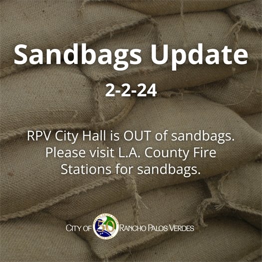 Sandbags are stacked to protect against storm runoff. A headline above the City of Rancho Palos Verdes logo says Sandbags Update, 2-2-24. A subhead says RPV City Hall is OUT of sandbags. Please visit L.A. County Fire Stations for sandbags. 