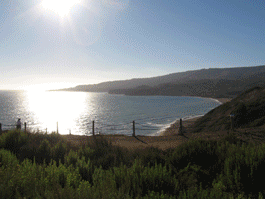 Images of park bench, covered picnic areas overlooking ocean and the sun setting over water